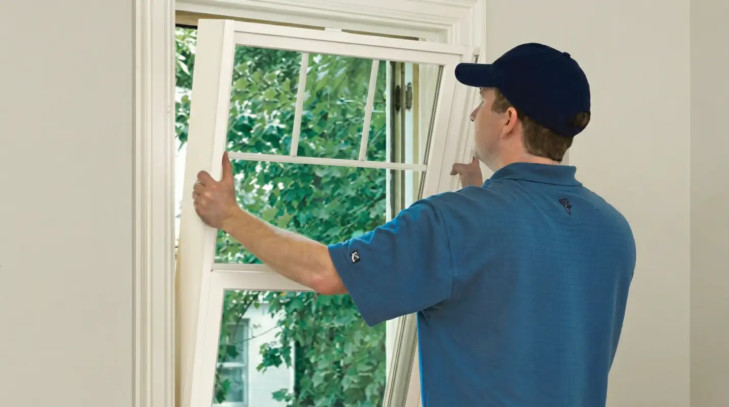 Professional contractors performing a residential window insulation and replacement service in Rockford, IL